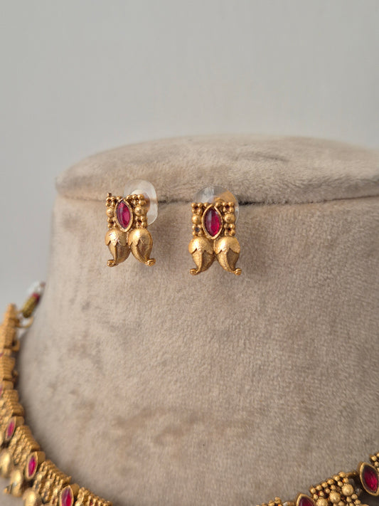 A showstopper piece with red stones and golden leaves design by naitri.in