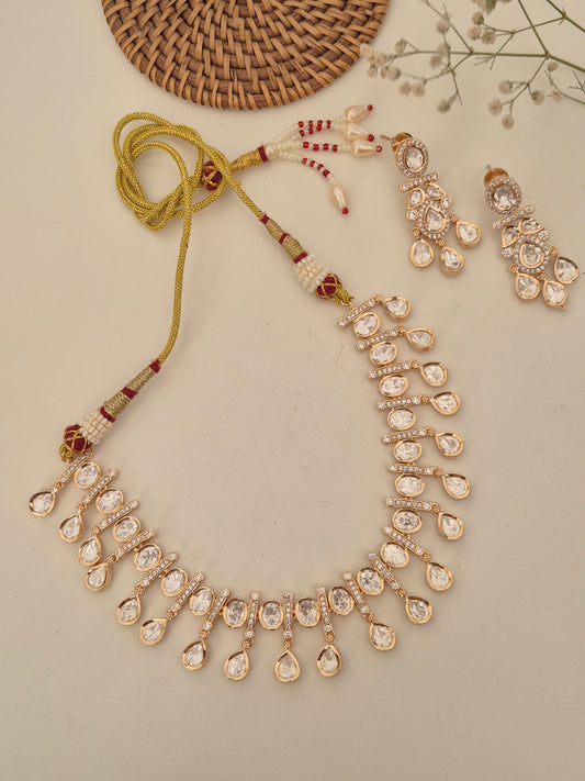 Opulent Victoria necklace set in a stately rose-gold finish, showcasing brilliant-cut American Diamond drops and matching floral-inspired earrings for festive occasions by naitri.in
