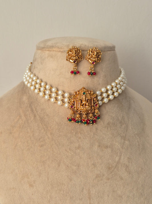 Set of gold jewelry with pearls chain Antique gold-plated choker necklace featuring a central Goddess Lakshmi motif, hanging colourful drops by naitri.in
