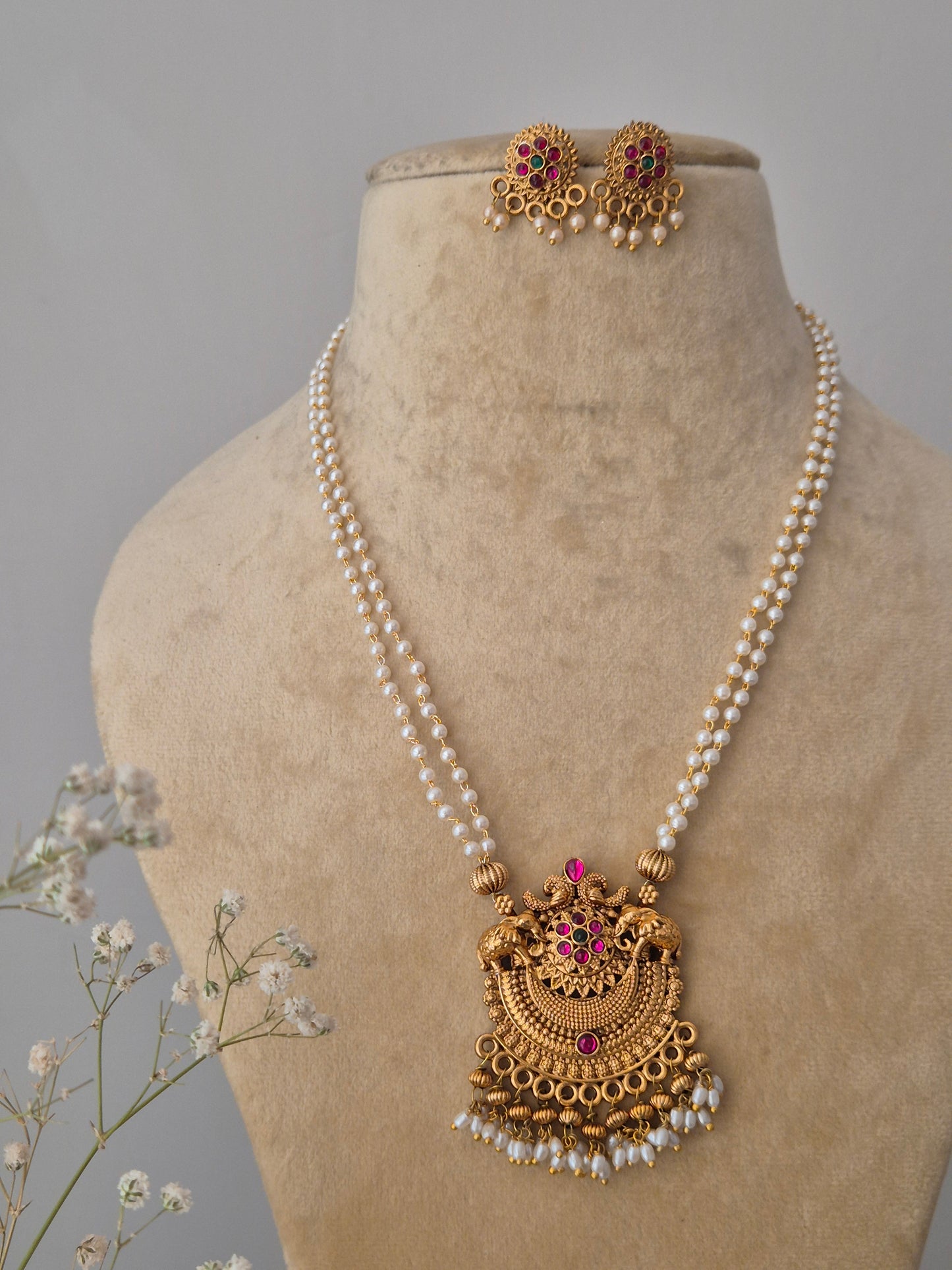Qiana Pearl Chain Necklace: Artisanal gold-finish pendant necklace with pink stones and coordinating jhumka-style stud earrings from the Naitri collection