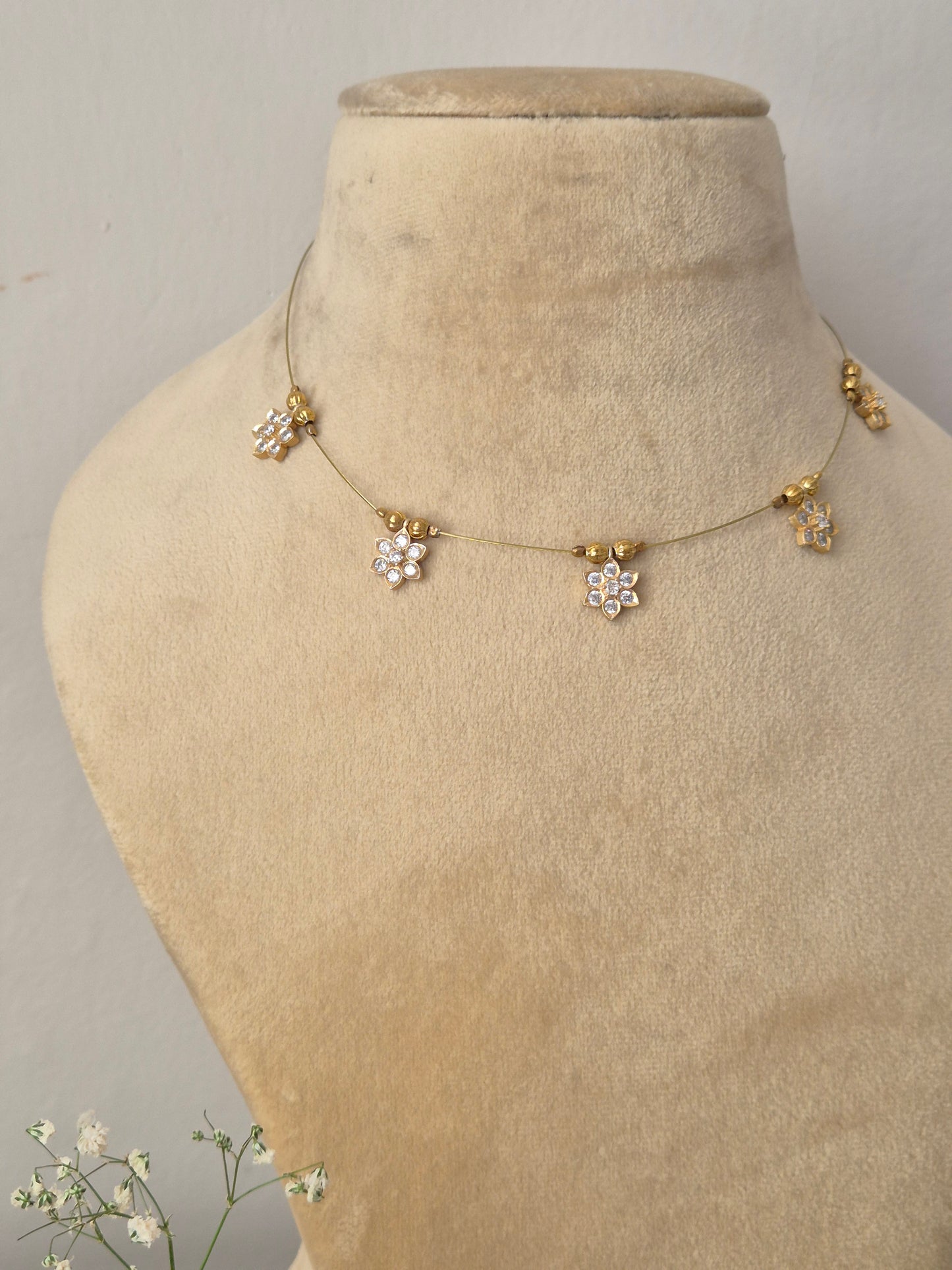 Modern Indian style delicate golden brass alloy pendant necklace, Handcrafted delicate gold invisible chain with floral crystal drops, by naitri.in