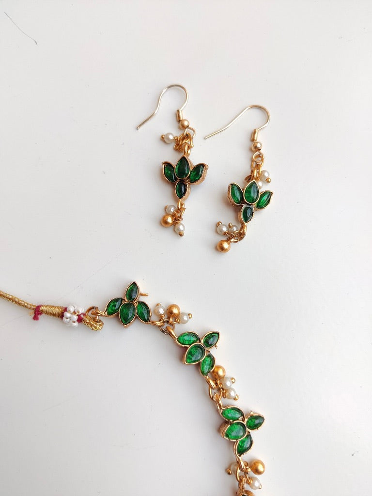Antique gold-plated Reversible Lotus Temple Jewellery Necklace Set with red and green stones.