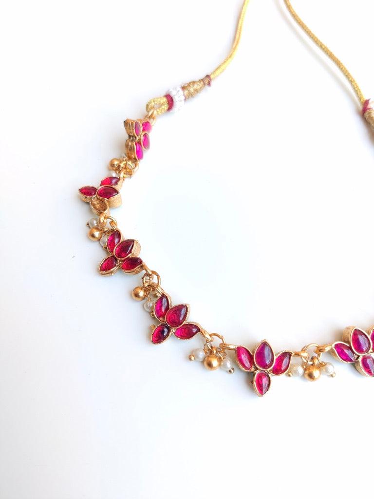 Antique gold-plated Reversible Lotus Temple Jewellery Necklace Set with red and green stones.