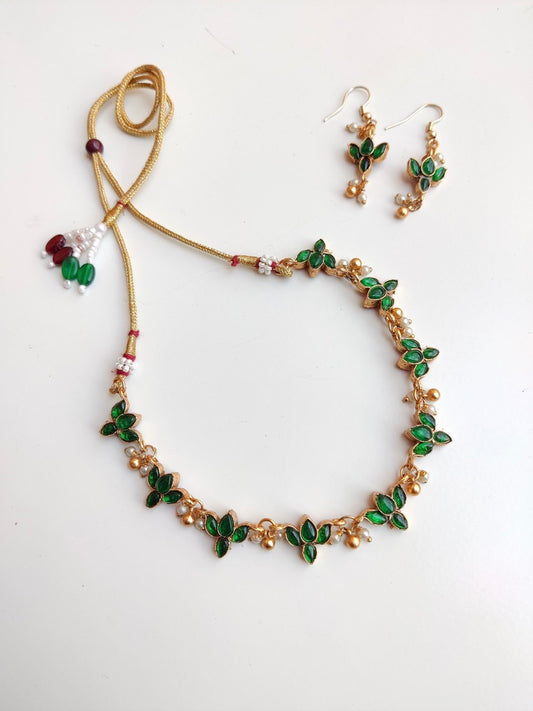 Antique gold-plated Reversible Lotus Temple Jewellery Necklace Set with red and green stones.