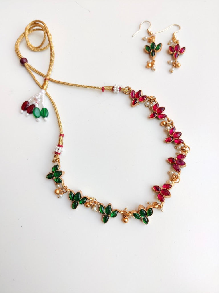 Antique gold-plated Reversible Lotus Temple Jewellery Necklace Set with red and green stones.