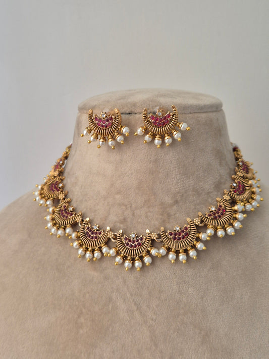 Detailed half moon and green stones in the middle with pearls attached outside eye-catching jewellery, Minimalist, a delicate hammered texture, necklace for modern ethnic wear and wedding by naitri.in