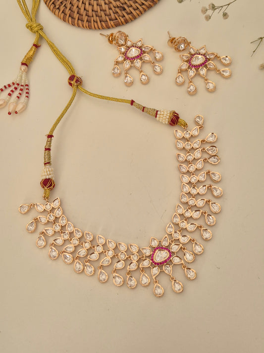 Handcrafted Rosalie necklace set made of polished alloy, featuring intricate American Diamond floral motifs and ruby-pink stone embellishments for a festive look by naitri.in