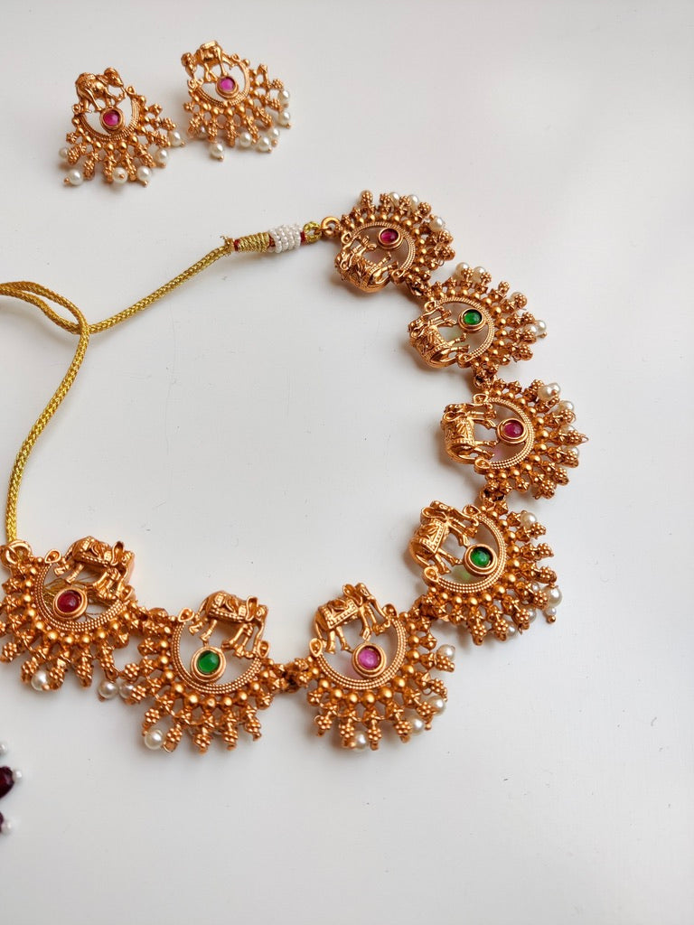 Antique gold-plated Royal Temple Jewellery Necklace Set with red and green stones.