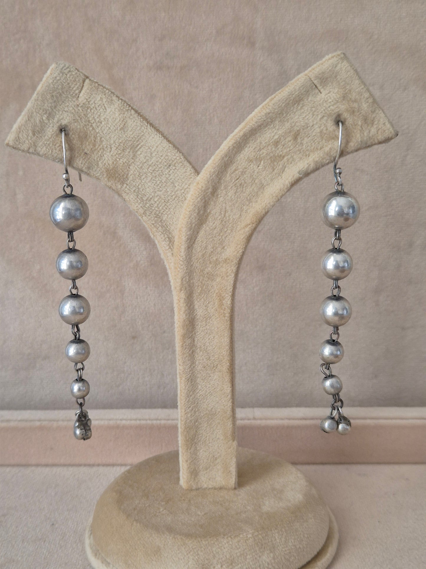 Naitri premium Sabina silver dangle earrings from the modern imitation jewellery collection, Handcrafted silver-plated linear drop earrings with round metallic accents by naitri.in
