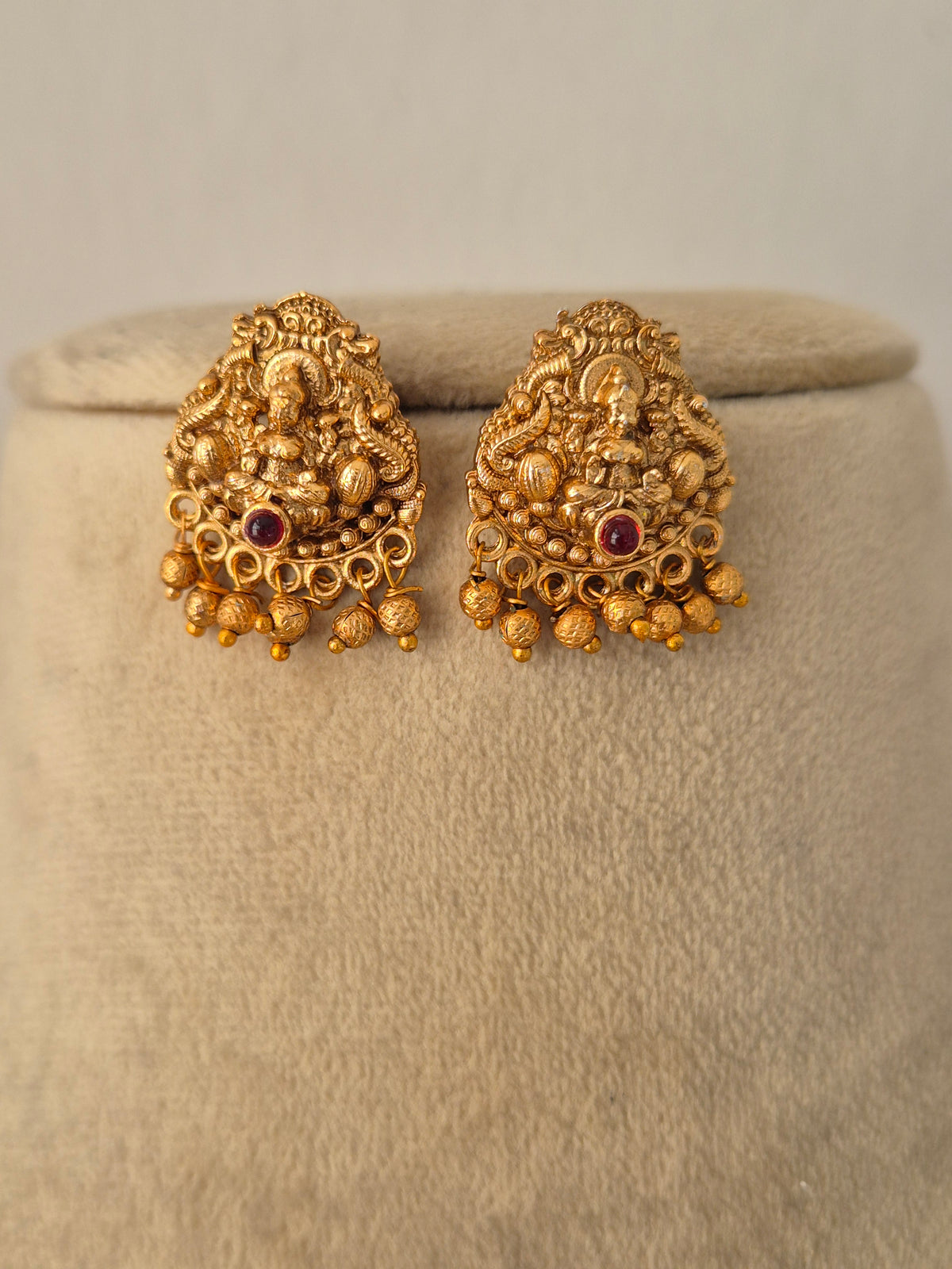 Traditional Indian ethnic gold earring set with gemstone details by Naitri.in