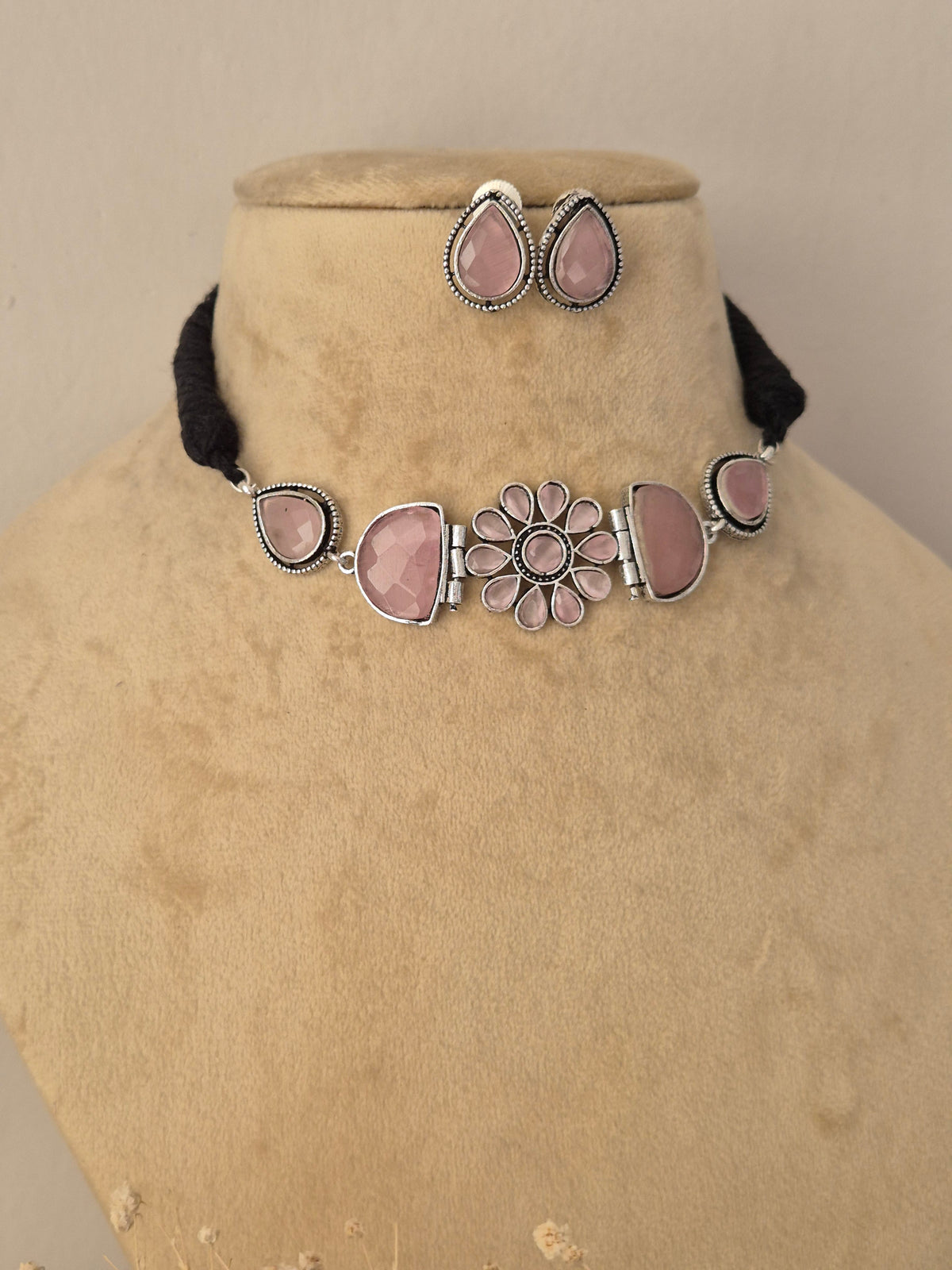 Artisan fashion jewelry set showcasing polished metallic detailing, delicate pink gemstones, and a classic Indian aesthetic by Naitri.in