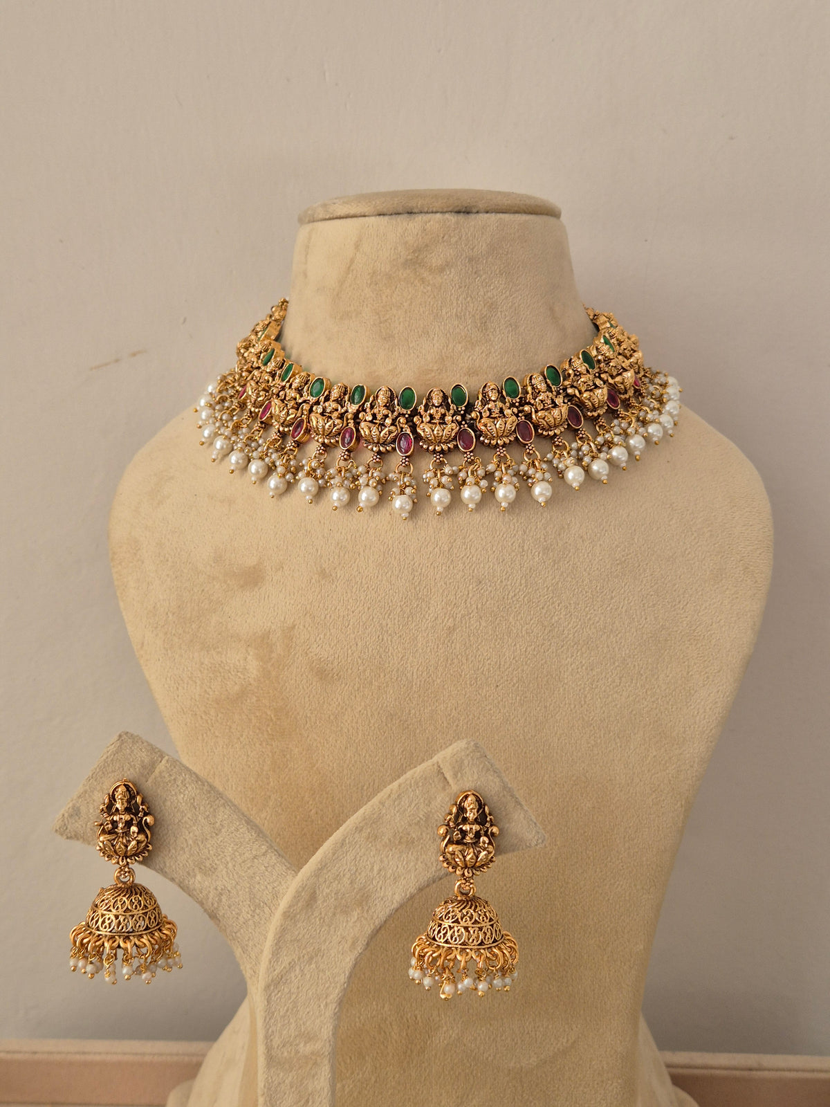Shreya Necklace Set - Antique gold temple jewelry choker with matching jhumka earrings, adorned with stones and pearls by Naitri.in