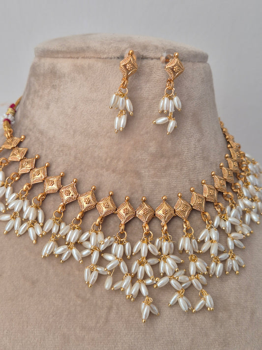 Gold and long shaped pearl jewelry perfect for wedding and festival light weight and easy to carry by naitri.in