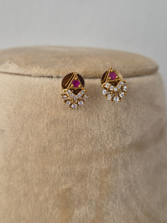Delicate gold-toned earring dangling ethnic charms accented with small pink and clear gemstones, by naitri.in