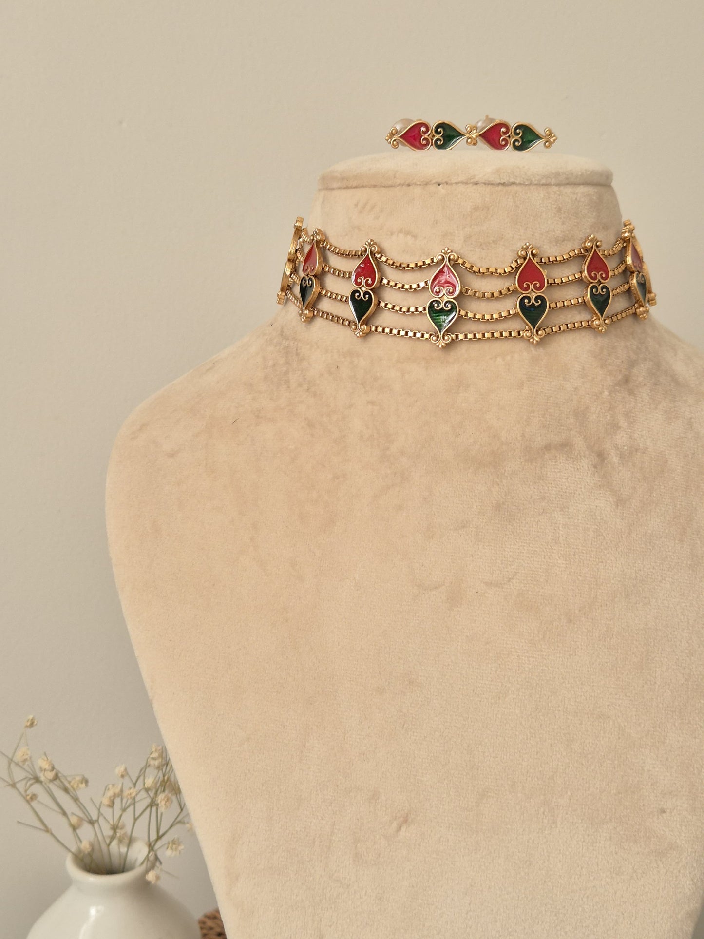 Elegant temple choker set detailed with gold, red, and green tones, shown on a neutral background