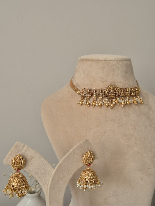 Distinctive temple necklace set blending bronze and gold tones, photographed to emphasize artisanal details