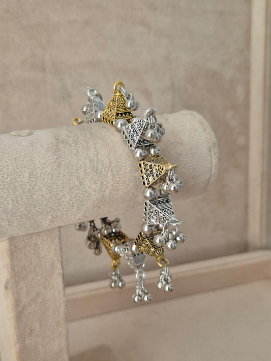 Close-up of Naitri Yachana premium mixed-metal ethnic bracelet showcasing traditional Indian tribal craftsmanship with a vintage, antique finish and hanging bell clusters by naitri.in