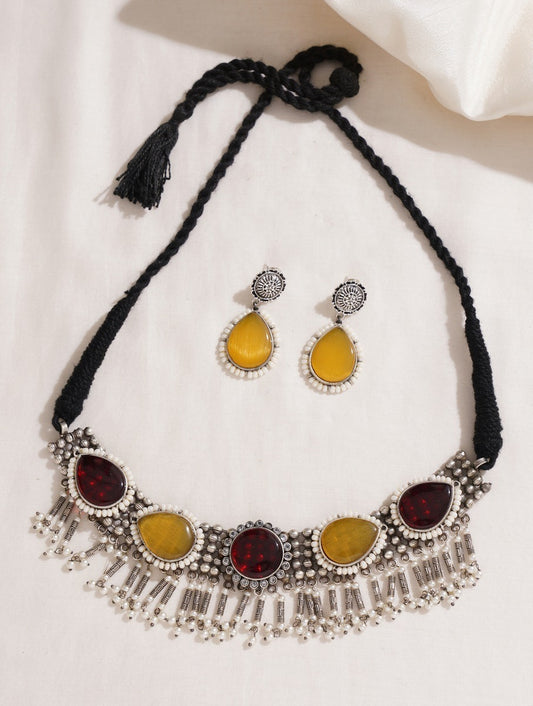 Woman wearing brass Sajini choker necklace and earrings set by Naitri.