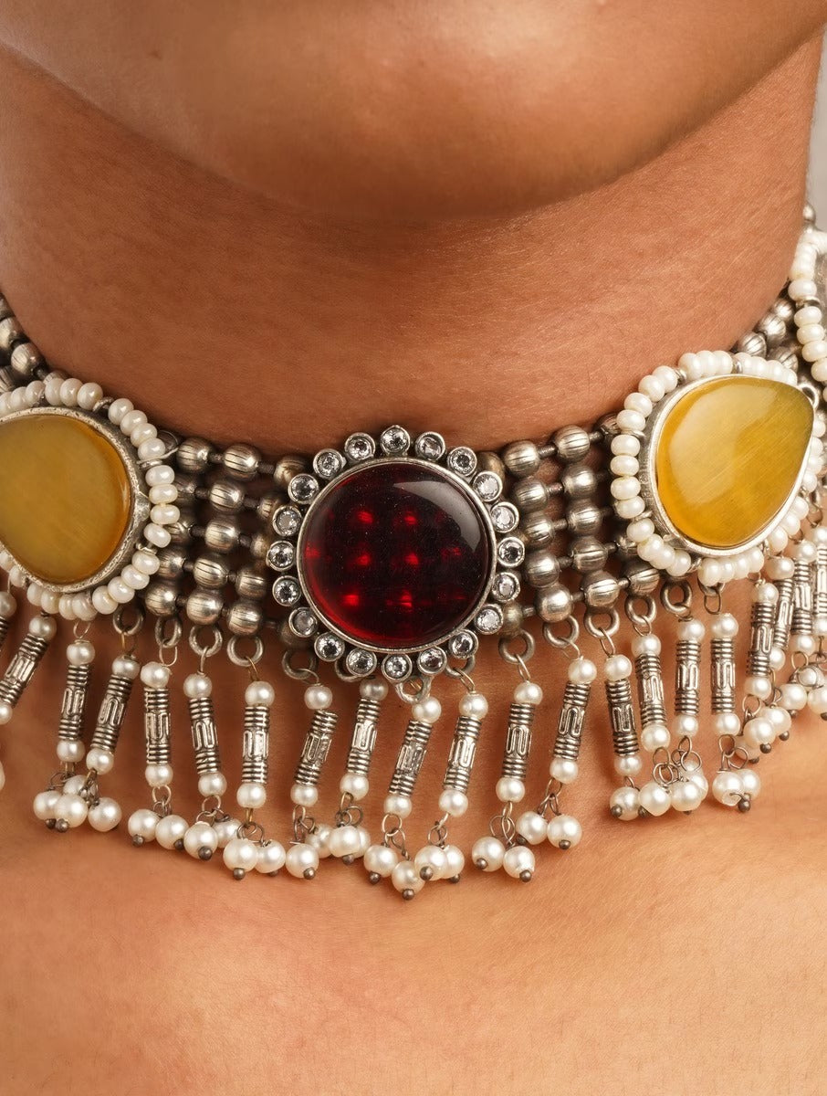 Woman wearing brass Sajini choker necklace and earrings set by Naitri.