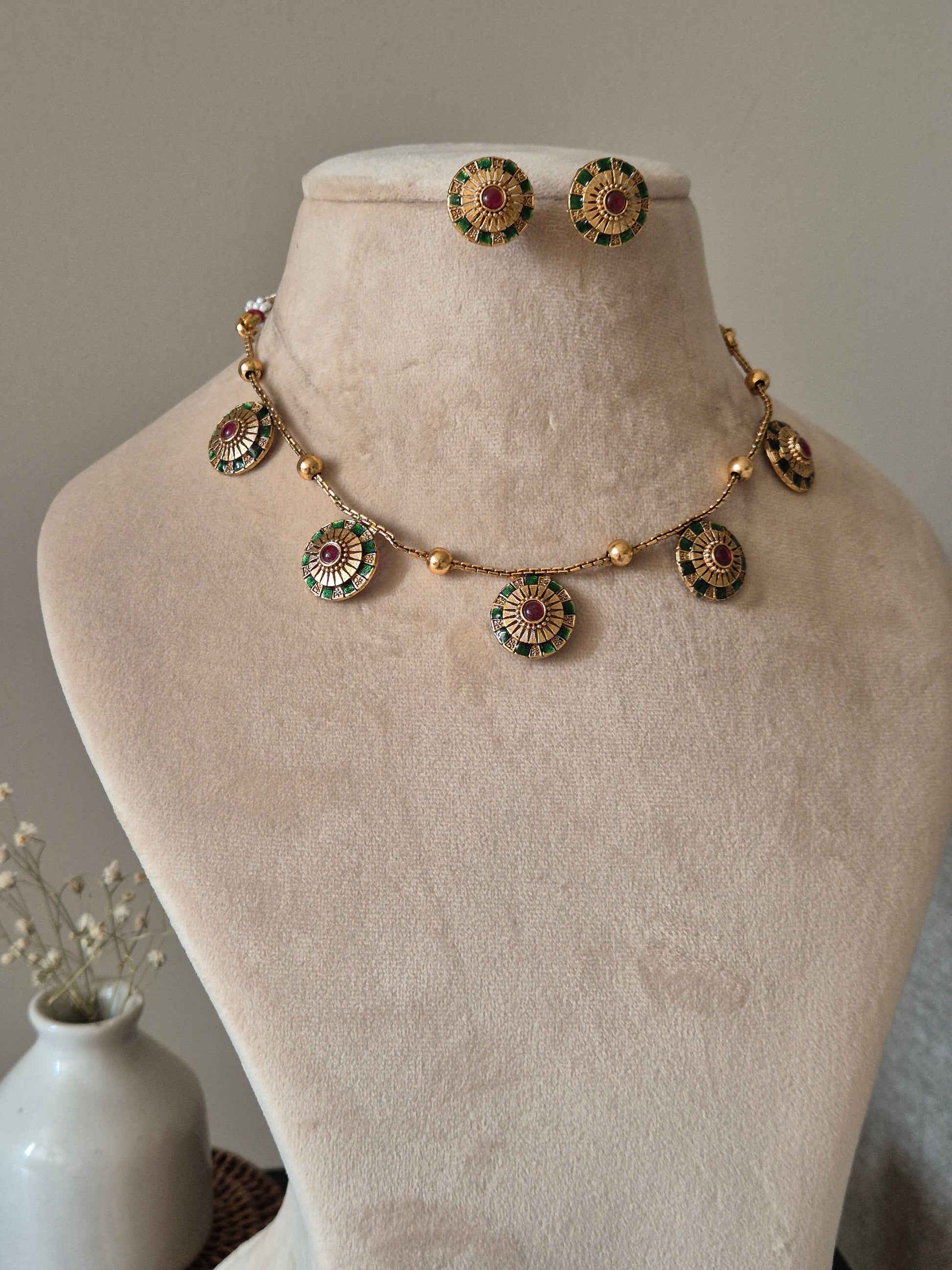 Close-up of ornate temple necklace set showcasing detailed metal craftsmanship with gold and silver tones