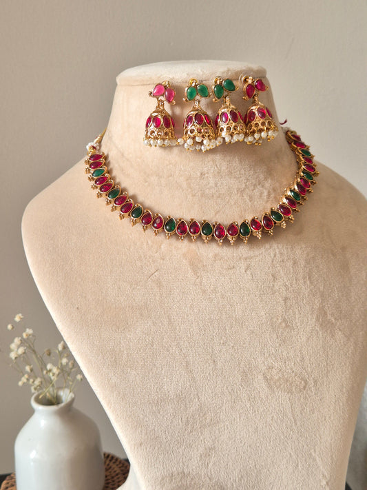 Unique reversible necklace set with pink, red, and green enamel, shown from multiple angles to illustrate versatility
