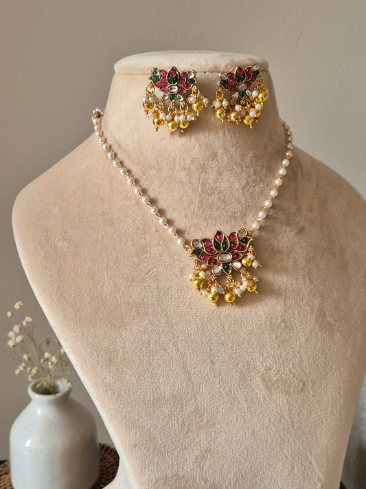 Temple necklace set with stud and dangle elements in gold-tone metal alloy, emphasizing detailed craftsmanship