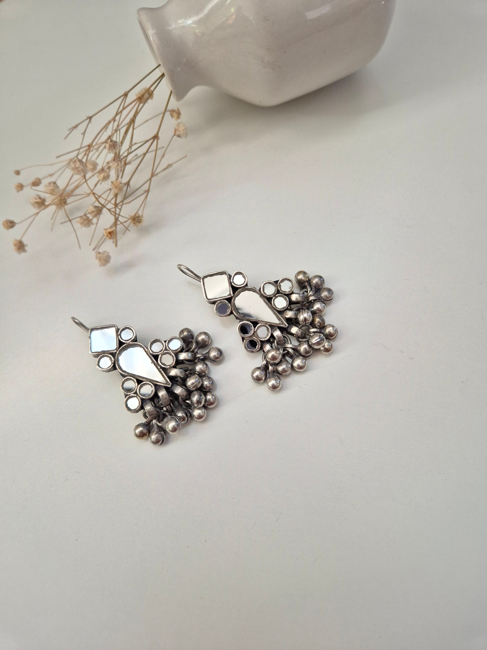 Silver glass dangle earrings, visible artistic metal details