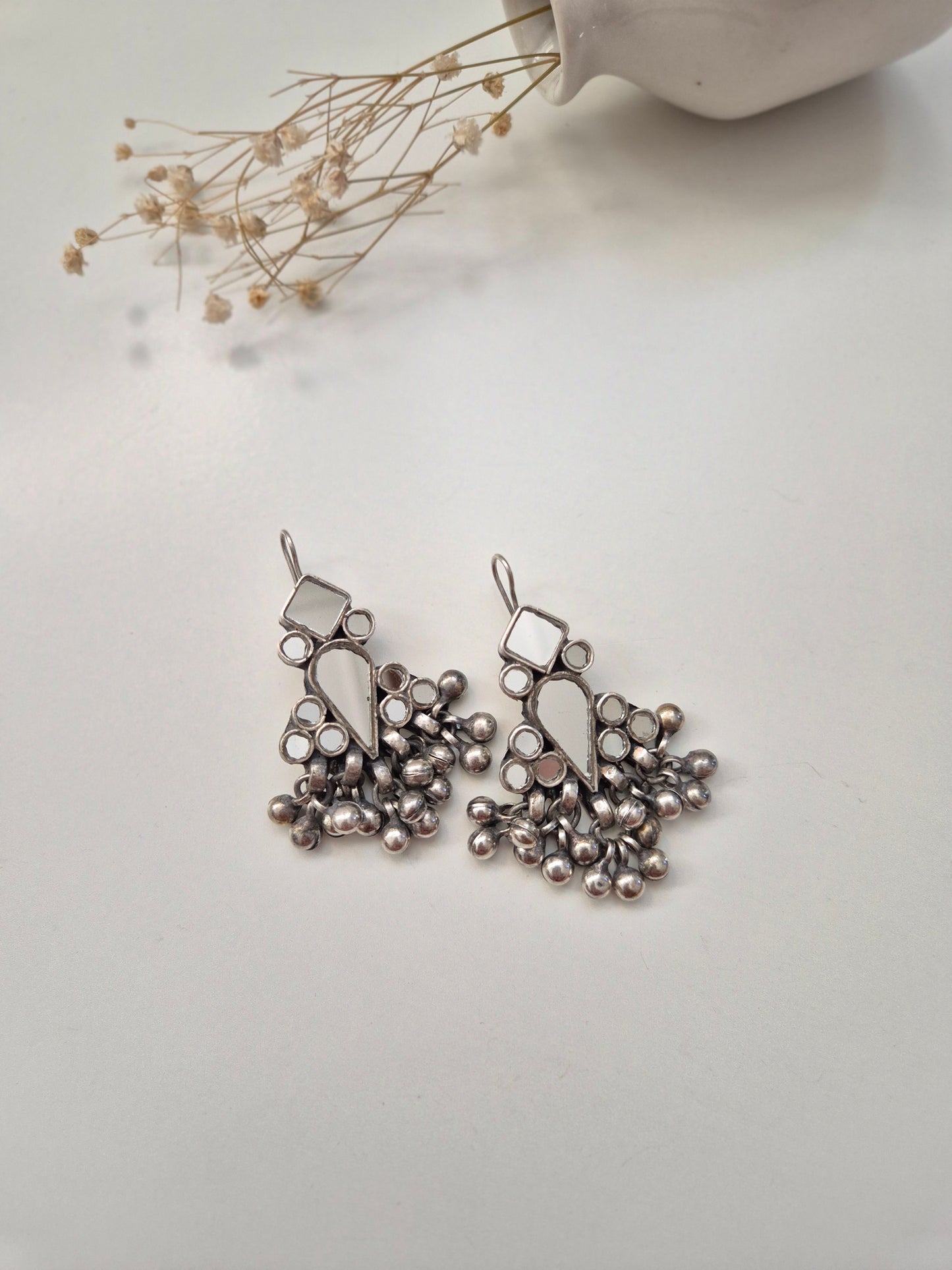 Silver glass dangle earrings, visible artistic metal details
