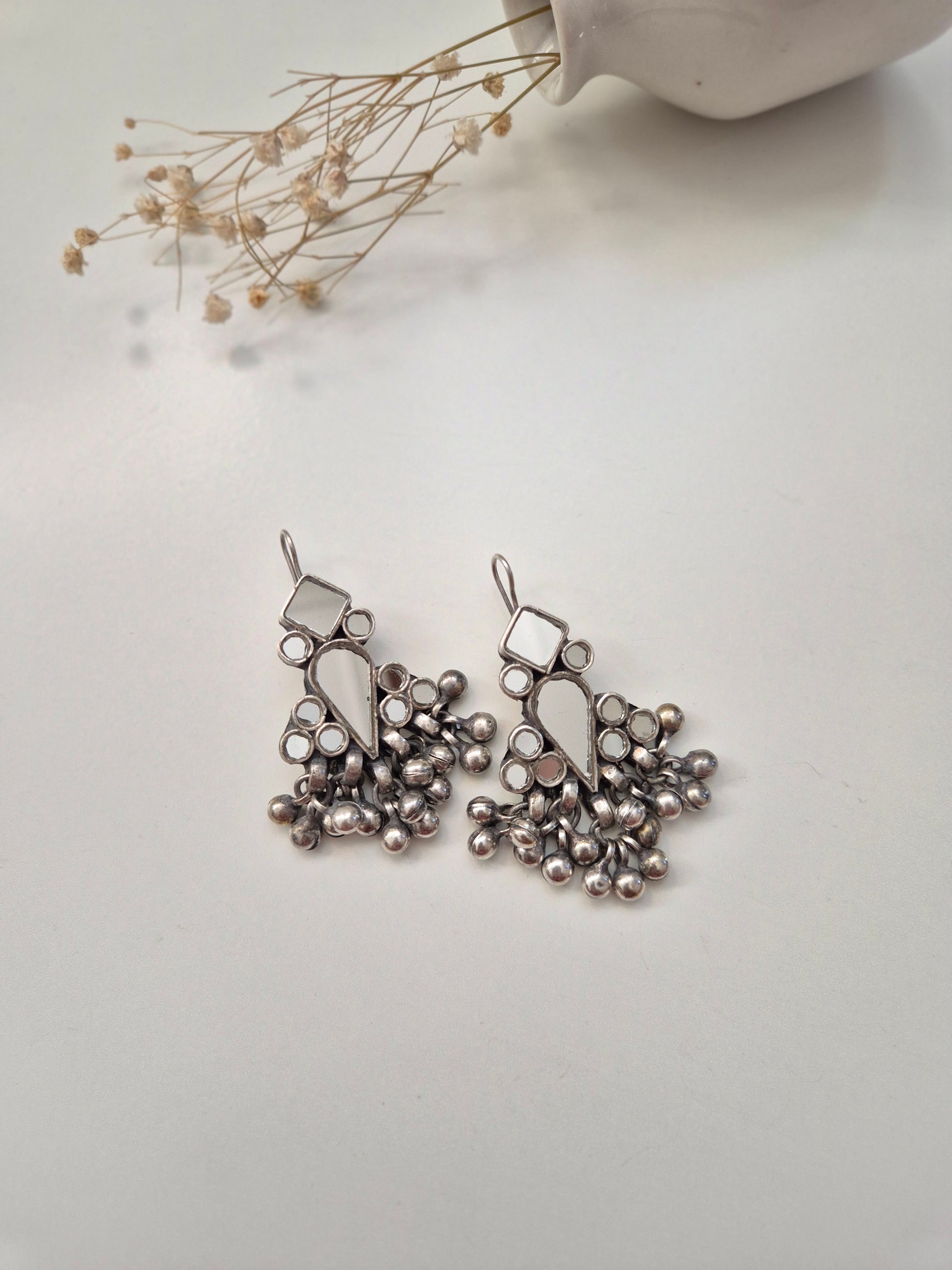 Silver glass dangle earrings, visible artistic metal details