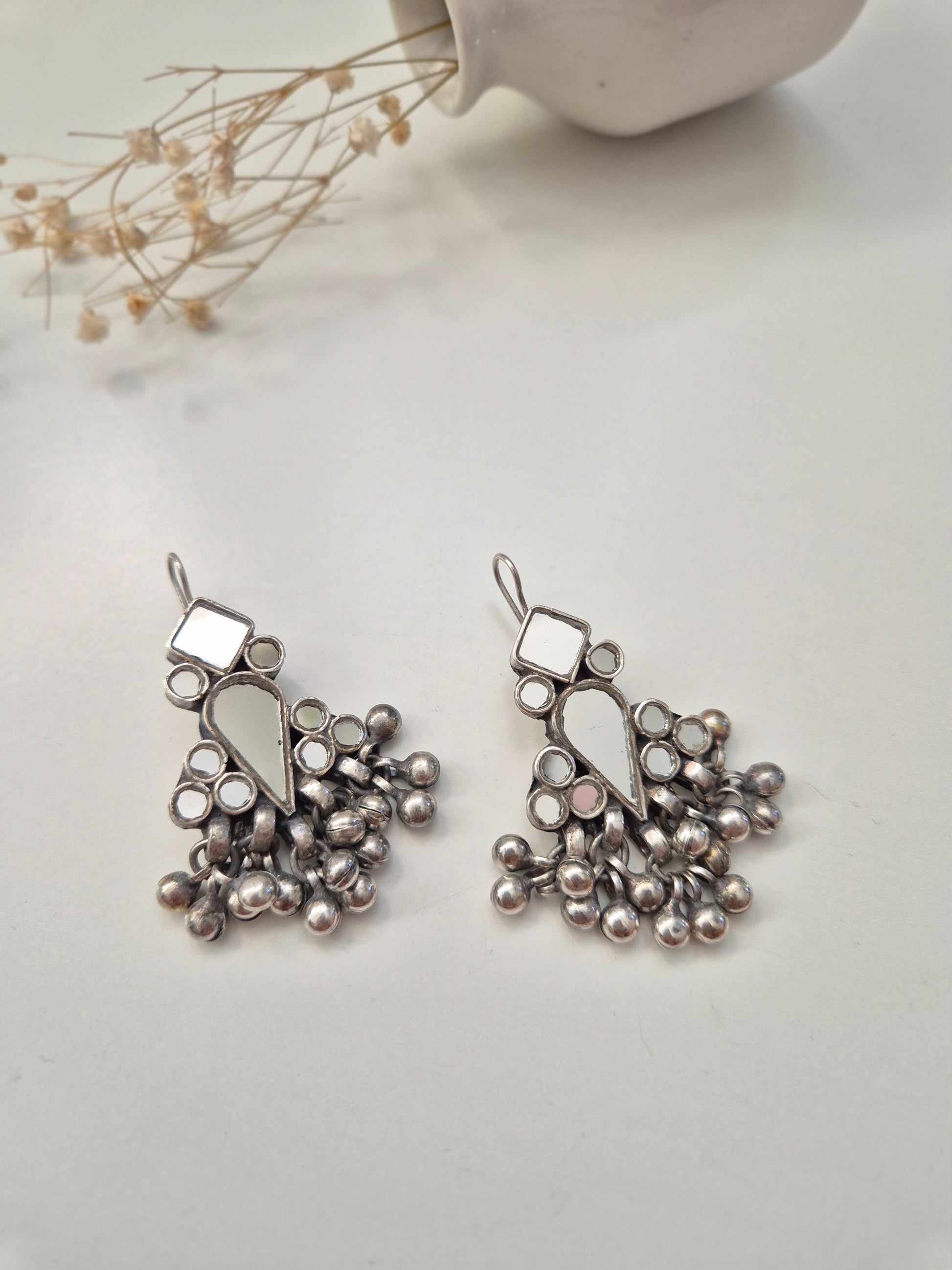 Silver glass dangle earrings, visible artistic metal details