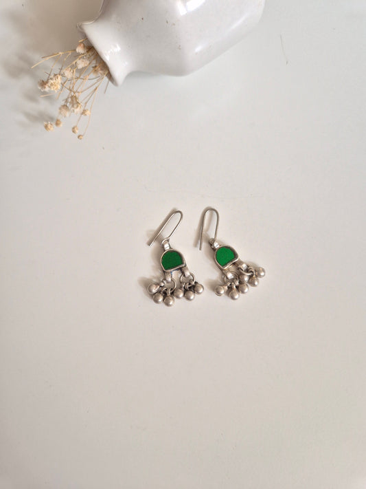 Green glass dangle earrings upright, artisanal finishing
