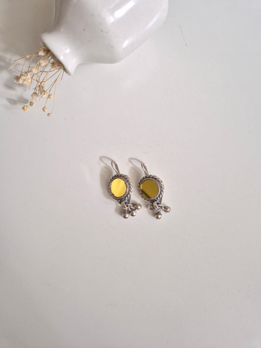 Silver and yellow glass dangle earrings standing upright