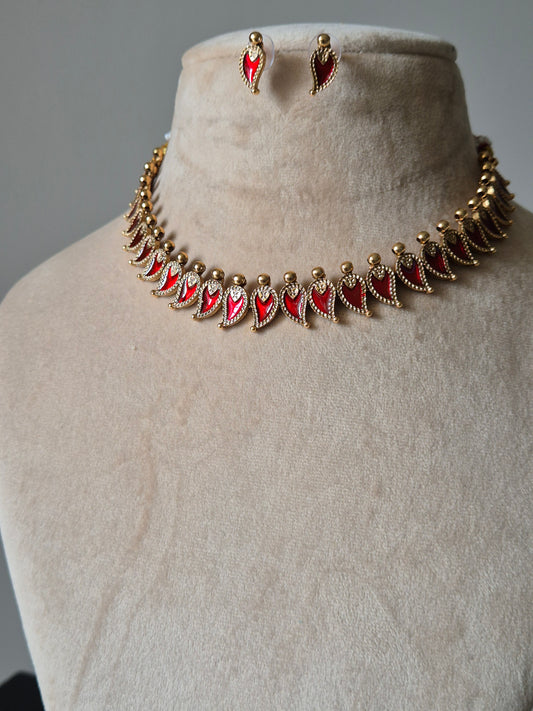 Gold and red necklace set, Aja by Naitri, displayed with matching earrings.