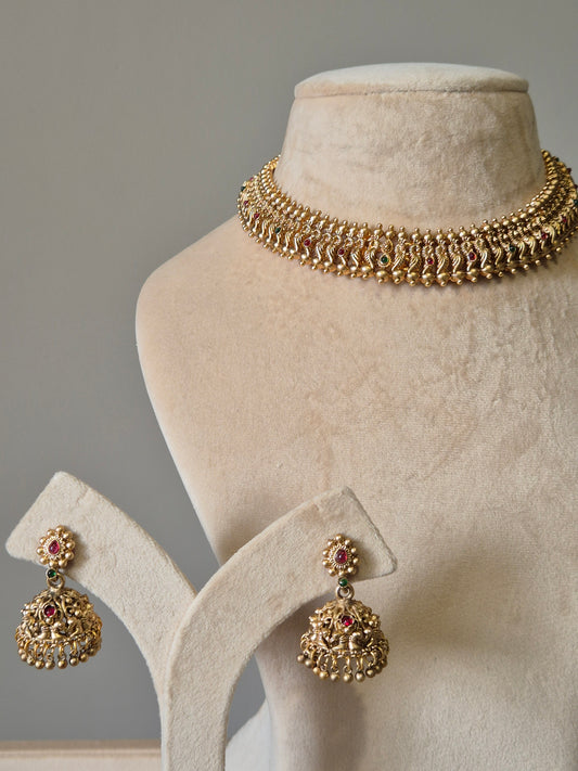 Gold necklace set with red stones, Lipsa by Naitri, classic design shown flat.