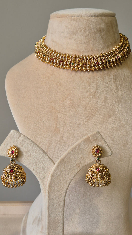 Gold necklace set with red stones, Lipsa by Naitri, classic design shown flat.