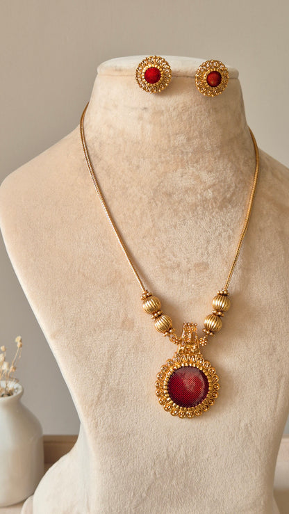 Golden necklace set, Arundhati by Naitri, shown with pendant and earrings.