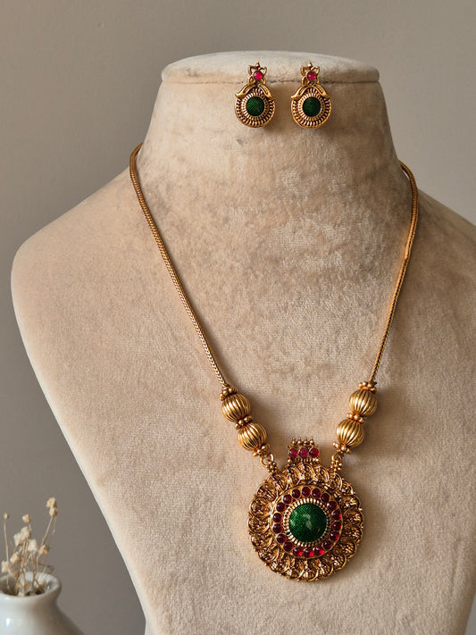Gold necklace set, Antika by Naitri, traditional style on soft background.