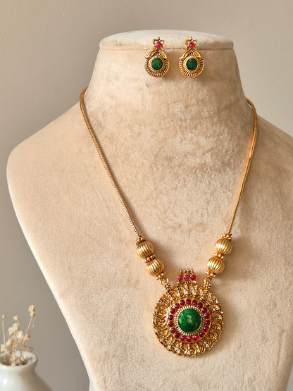 Gold necklace set, Antika by Naitri, traditional style on soft background.