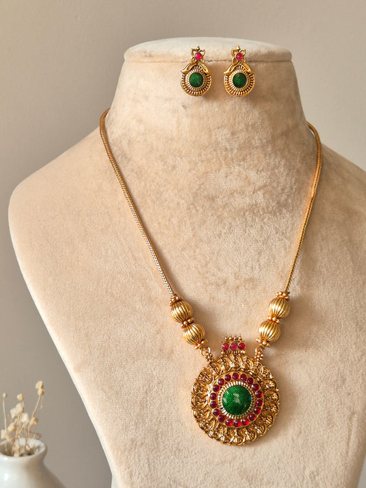 Gold necklace set, Antika by Naitri, traditional style on soft background.