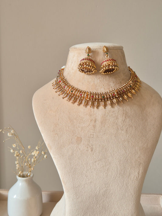 Gold necklace set with hanging coins, Rajasi by Naitri on white bust form.