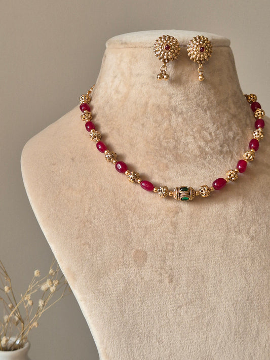 Red and gold beaded necklace set, Diya by Naitri with matching earrings.