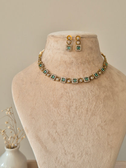 Blue and gold necklace set with clear stones, Tarang by Naitri on bust.