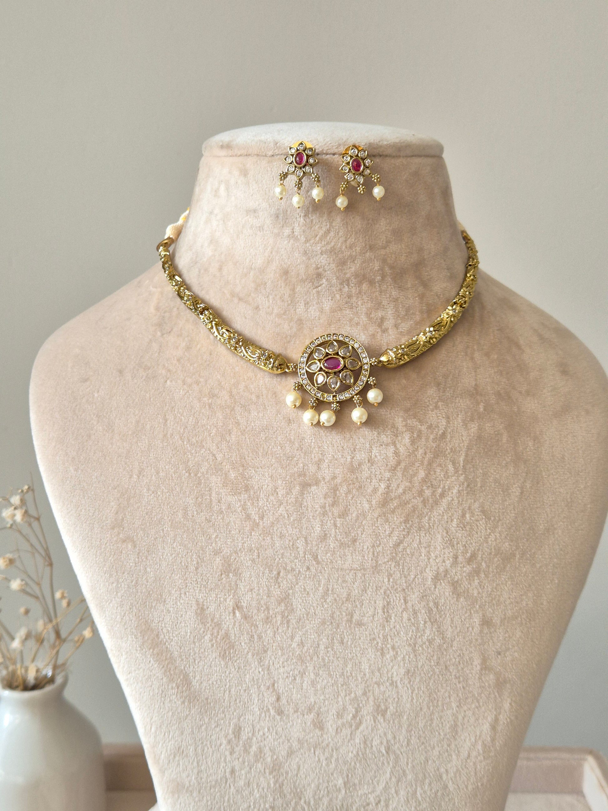 Gold necklace set with matching earrings, Vasundhra by Naitri on white background.