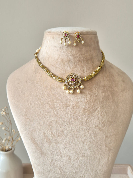 Gold necklace set with matching earrings, Vasundhra by Naitri on white background.
