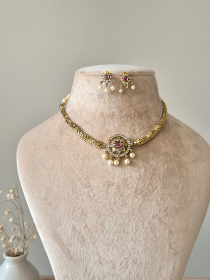 Gold necklace set with matching earrings, Vasundhra by Naitri on white background.