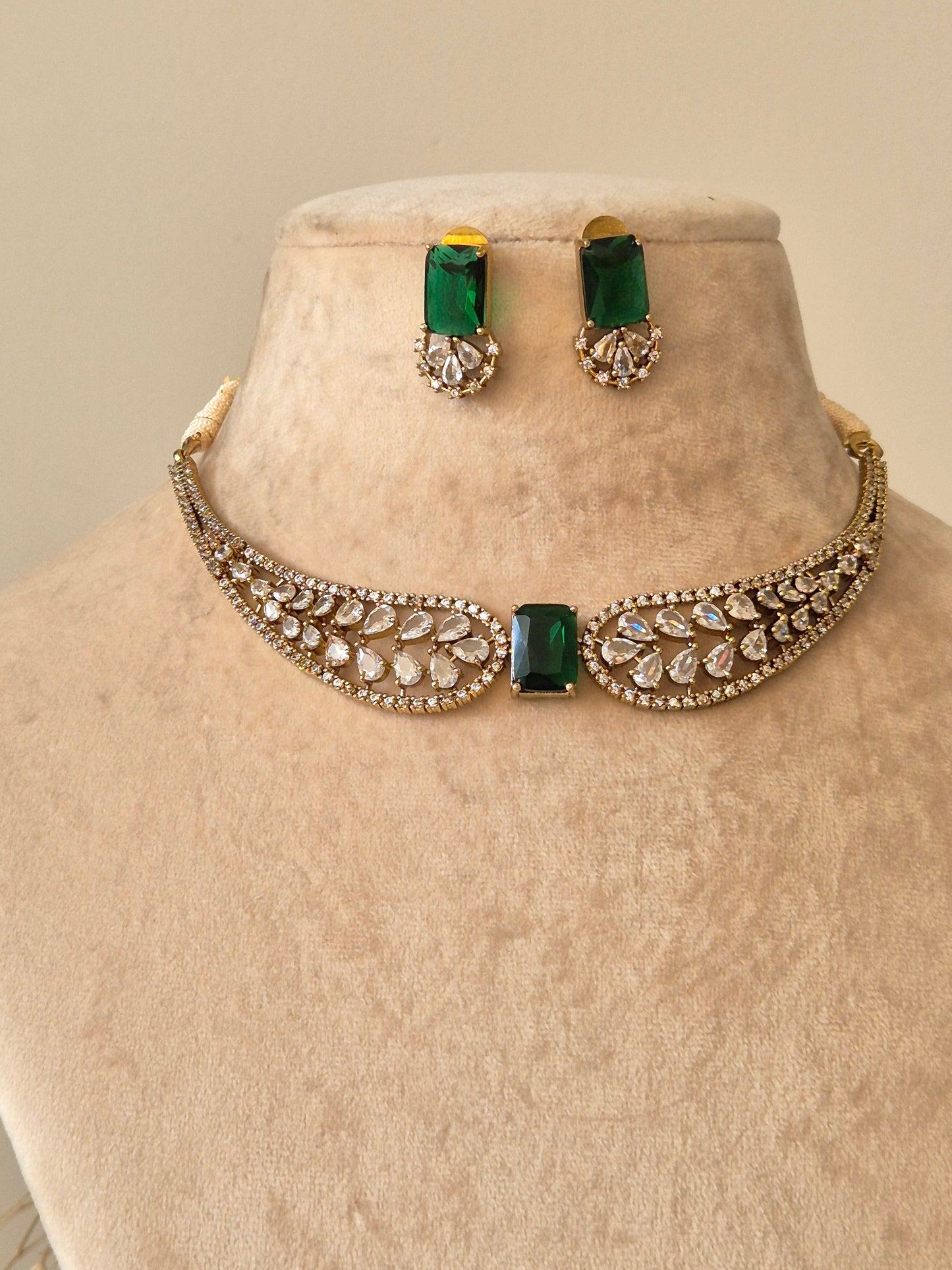 Polished gold necklace set with American diamond stones, Krishvi by Naitri.