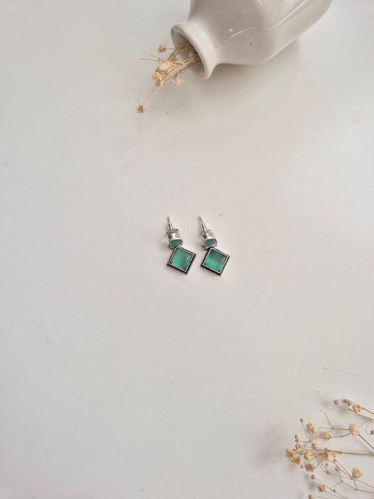 Oxidized Anisha Earrings with green glass accents, versatile handcrafted accessory.