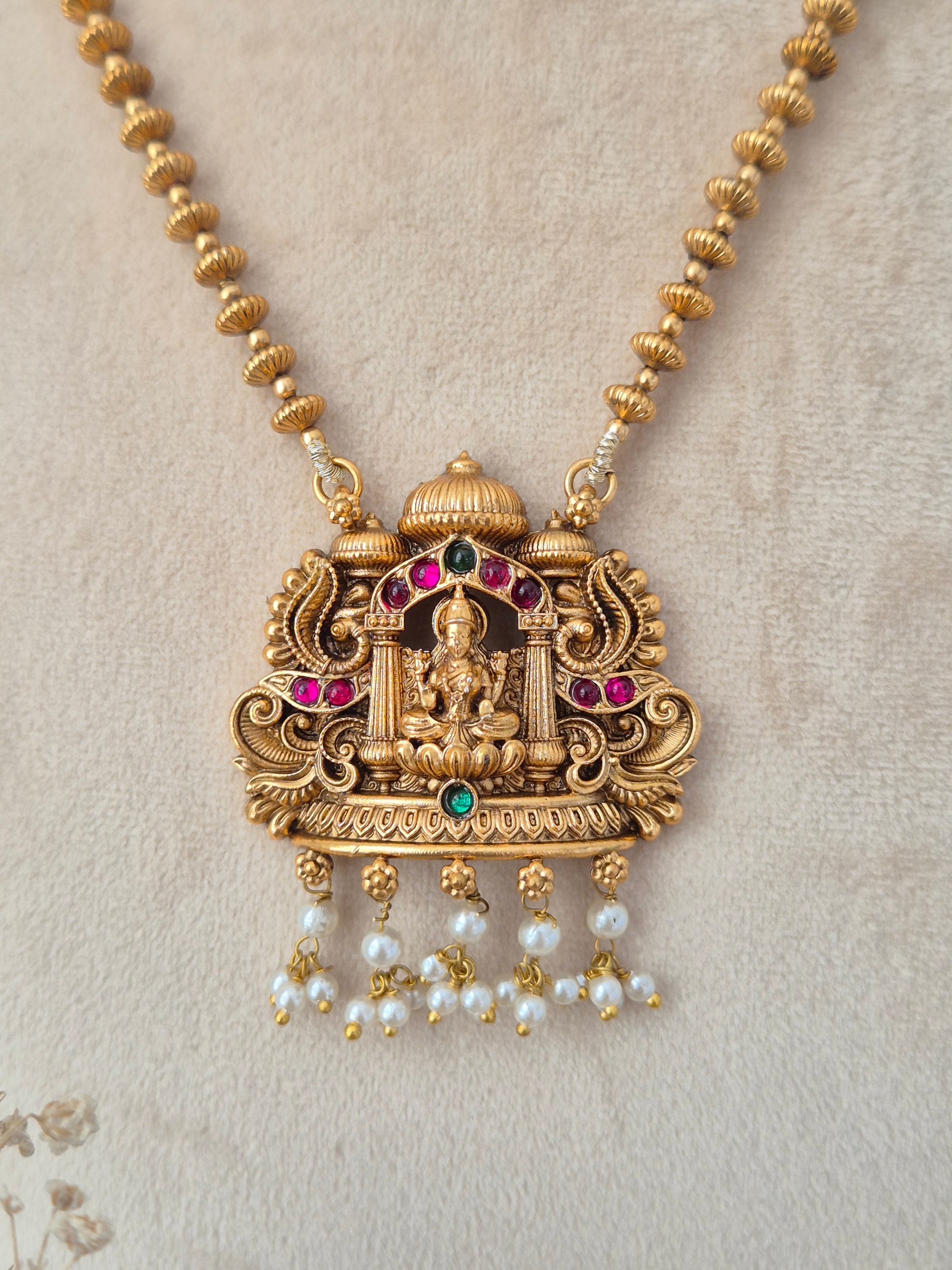 Yamira long gold temple necklace set with Laxmi pendant and pearl drops