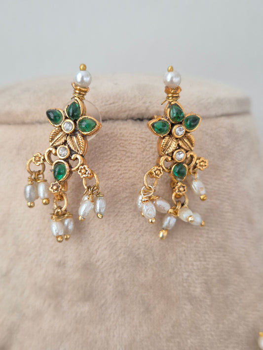 Gold-toned floral drop earrings with green stones, white stone accents, and dangling pearl clusters from the Ladli set