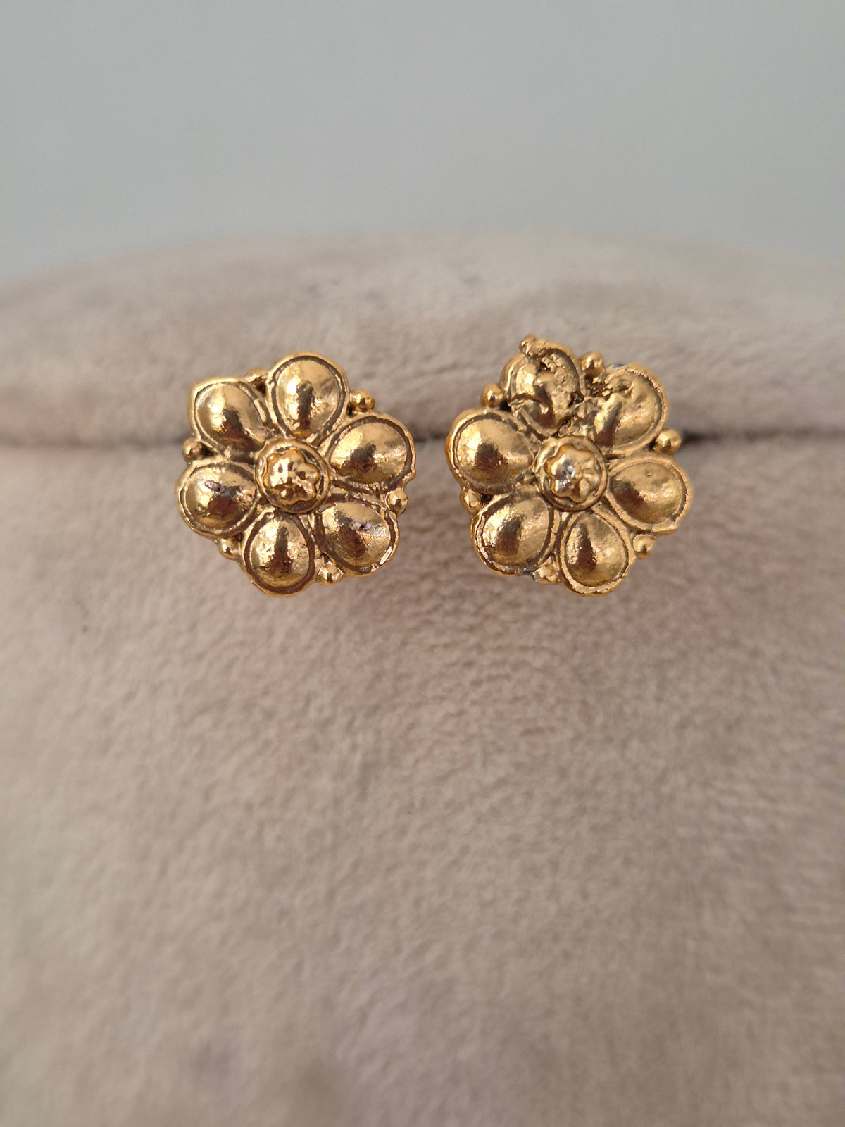 Gold-toned floral stud earrings with a textured petal design from the Lekhani necklace set